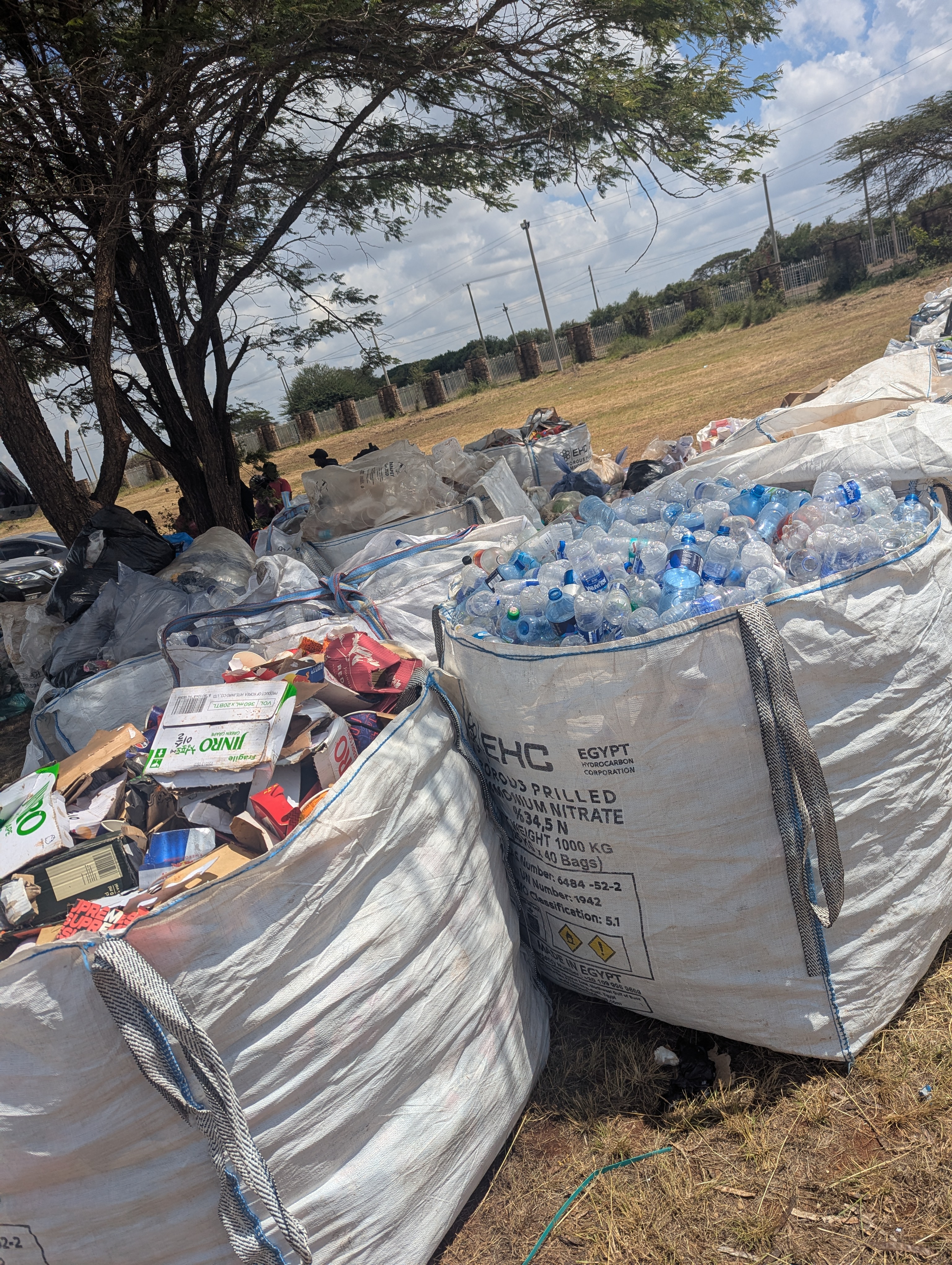 Bulk bags of sorted plastic bottles, cardboard and paper waste, ready for processors.
