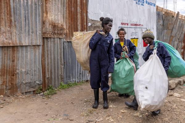 Three Zero Waste Events team members in protective gear with collection sacks at a Nairobi event.